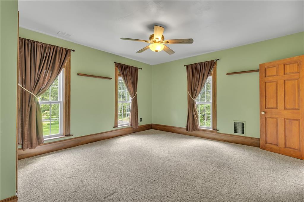 188 Logtown Road Darlington, PA 16115 - Photo 20 of 36 an empty room with windows and ceiling fan