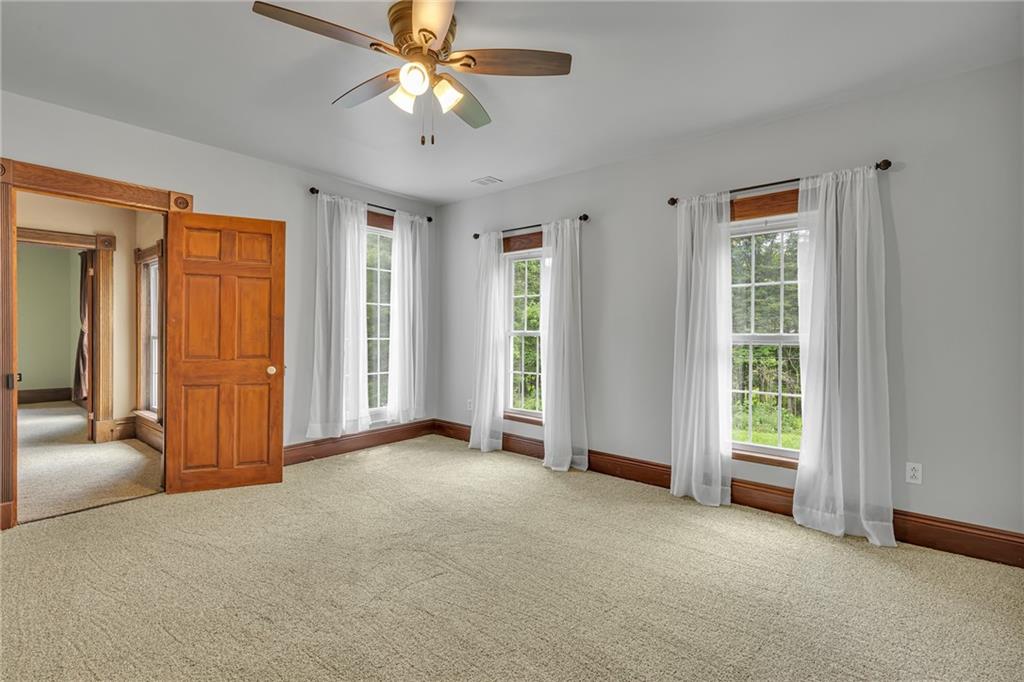 188 Logtown Road Darlington, PA 16115 - Photo 21 of 36 an empty room with windows and a chandelier fan