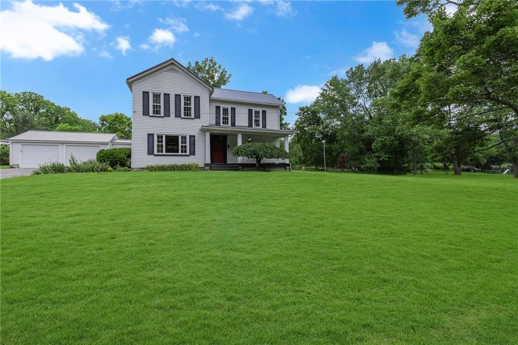 188 Logtown Road Darlington, PA 16115 - Photo 35 of 36 a house that is sitting in the grass with large trees and plants
