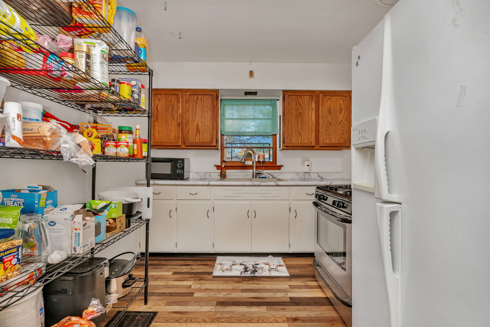 24646 West Eames Street Channahon, IL 60410 - Photo 12 of 32 a kitchen with stainless steel appliances granite countertop a stove a sink and a refrigerator