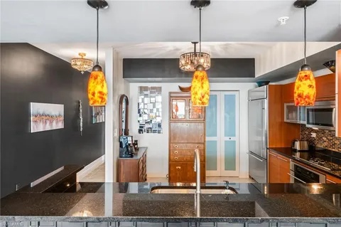 a view of a living room with wooden floor and chandelier