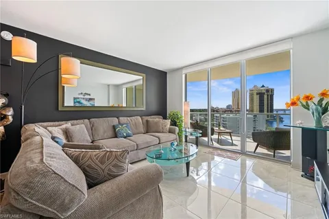 a living room with furniture and a floor to ceiling window