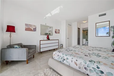 a spacious bedroom with a bed and a couch