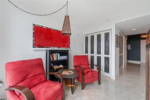 a bathroom with a granite countertop sink a toilet a mirror a bathtub and shower