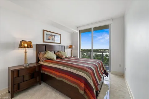 a bedroom with double bed and a window