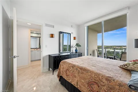 a bedroom with a large bed and a flat screen tv