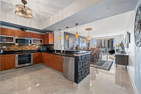 a kitchen with stainless steel appliances granite countertop a stove and a sink