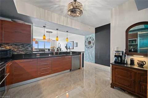 a large kitchen with stainless steel appliances granite countertop a stove a sink and a refrigerator