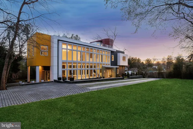 a view of a big house with a big yard and large trees