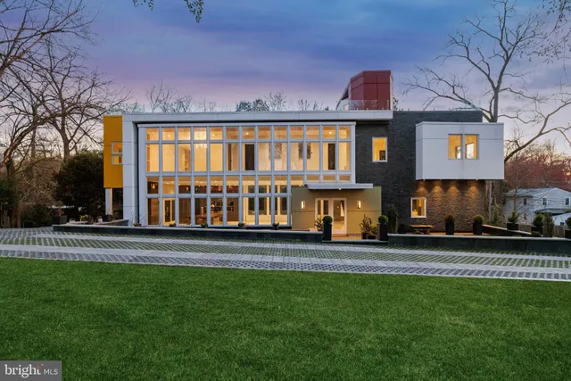 a view of a big house with a big yard and large trees