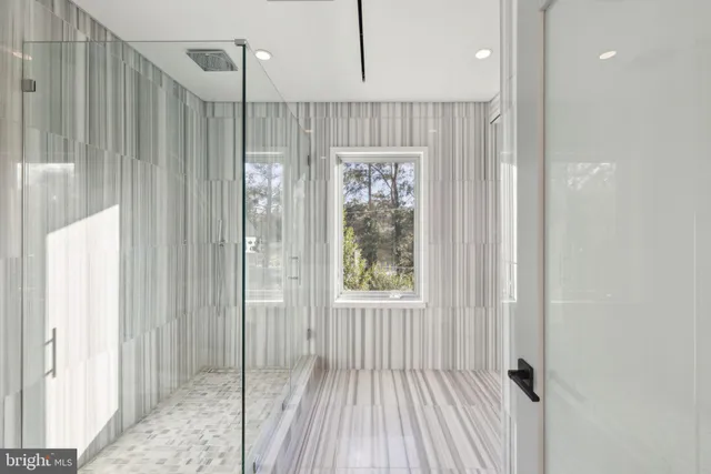 a bathroom with a sink a mirror and a shower