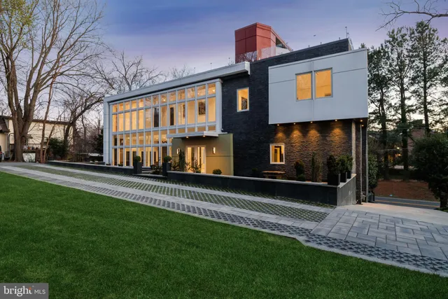 a view of a house with a yard and a tree