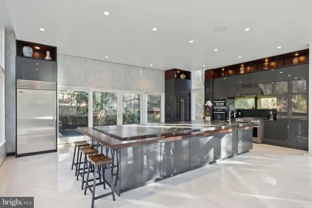 a kitchen with stainless steel appliances granite countertop a refrigerator and a sink