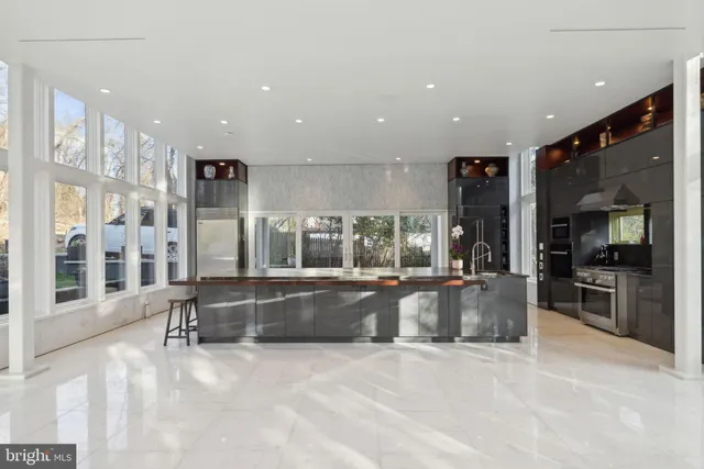 a large living room with a large window and chandelier