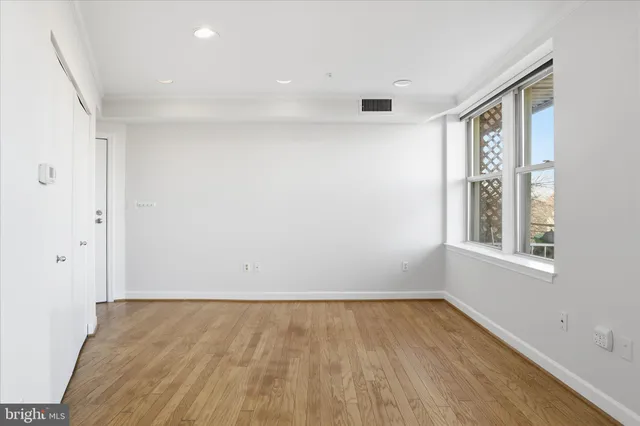 a living room with furniture a rug and a large window