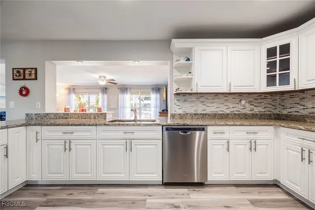 a kitchen with stainless steel appliances granite countertop a sink and cabinets