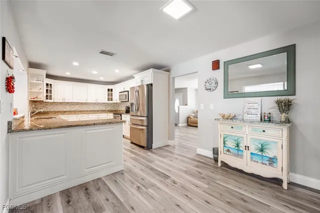 a kitchen with stainless steel appliances a refrigerator and a stove top oven