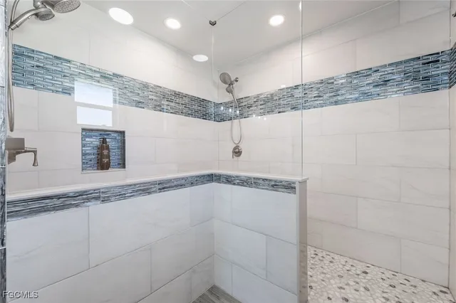 a bathroom with a shower and vanity