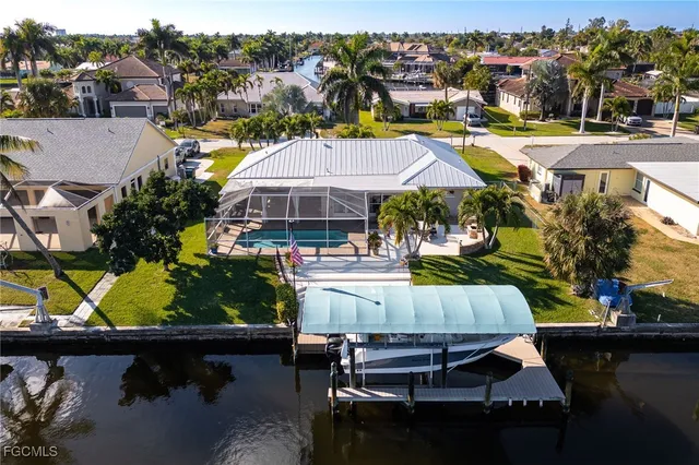 an aerial view of a house with swimming pool patio and outdoor seating
