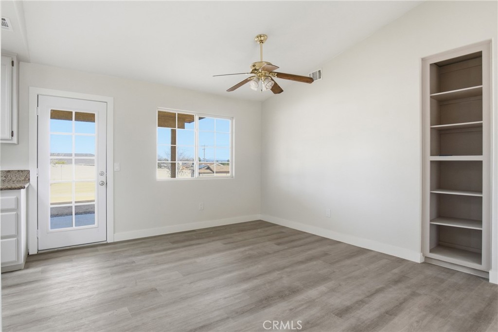17964 Hackberry Street Hesperia, CA 92345 - Photo 14 of 32 an empty room with wooden floor closet and windows