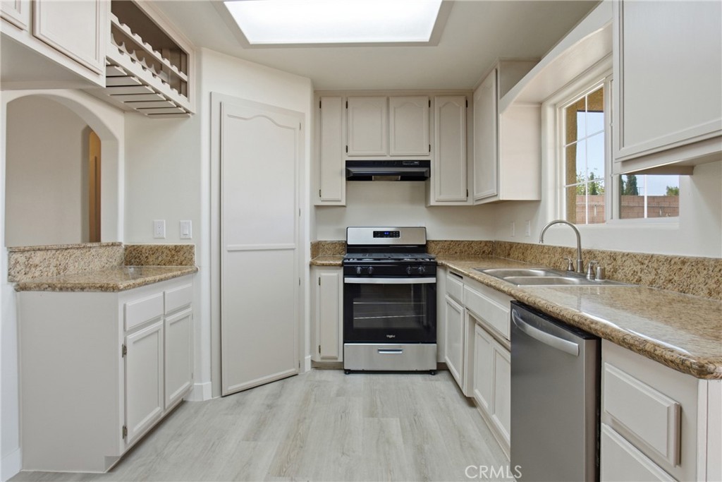 17964 Hackberry Street Hesperia, CA 92345 - Photo 16 of 32 a kitchen with stainless steel appliances granite countertop a sink stove and refrigerator