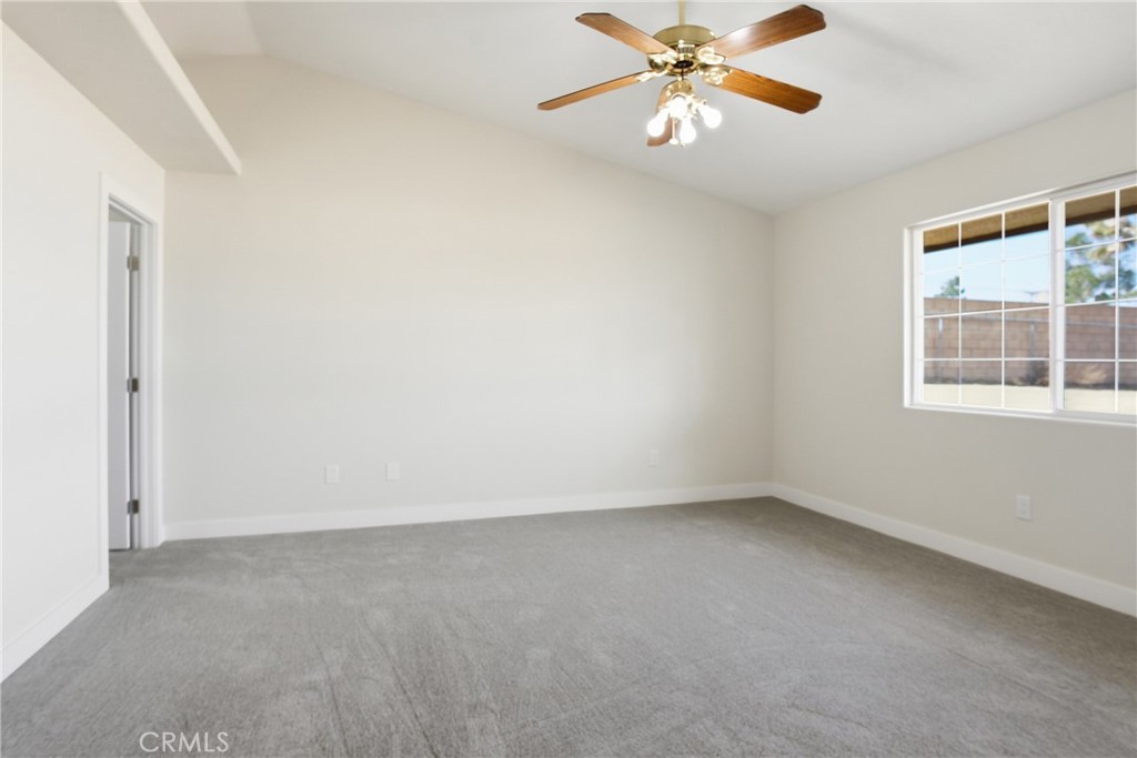17964 Hackberry Street Hesperia, CA 92345 - Photo 19 of 32 an empty room with a window and a fan