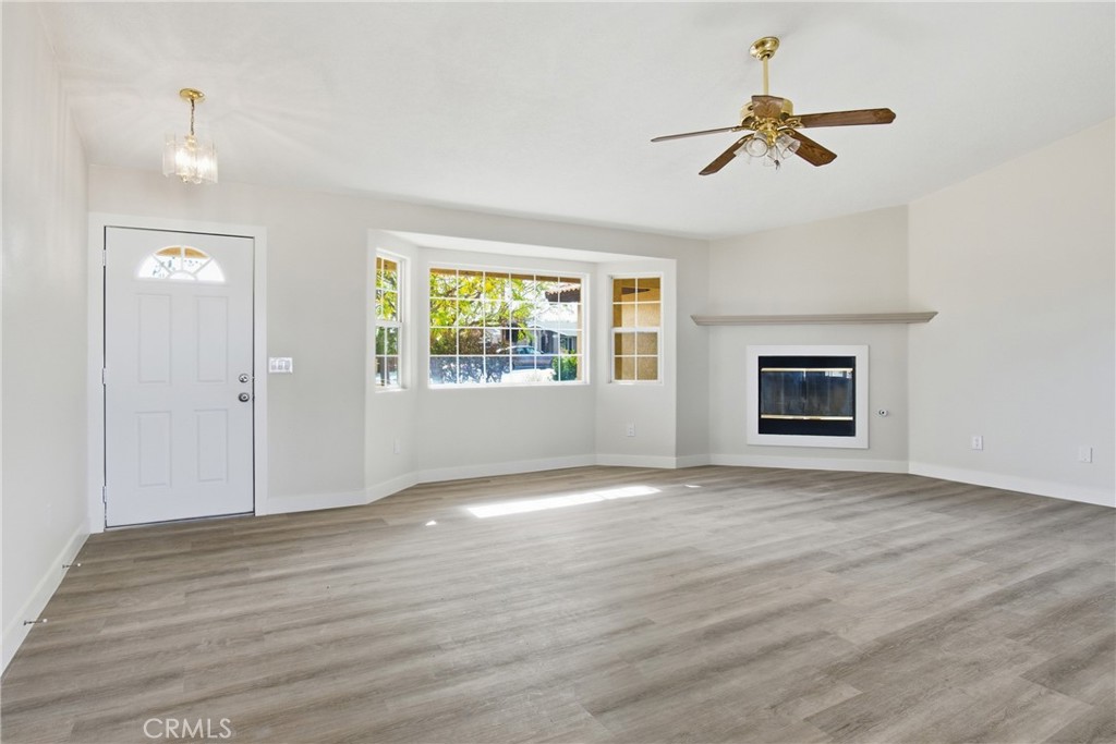 17964 Hackberry Street Hesperia, CA 92345 - Photo 5 of 32 a view of empty room with wooden floor and window