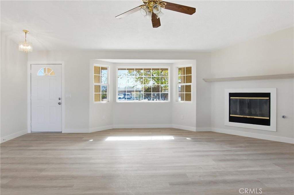 17964 Hackberry Street Hesperia, CA 92345 - Photo 6 of 32 a view of an empty room with wooden floor and a window