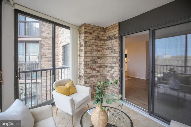 a living room with furniture and a floor to ceiling window