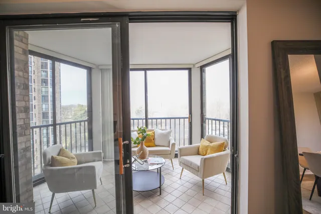 a balcony with furniture and a potted plant