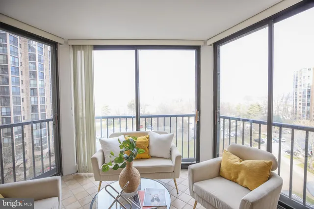a balcony with furniture and a potted plant
