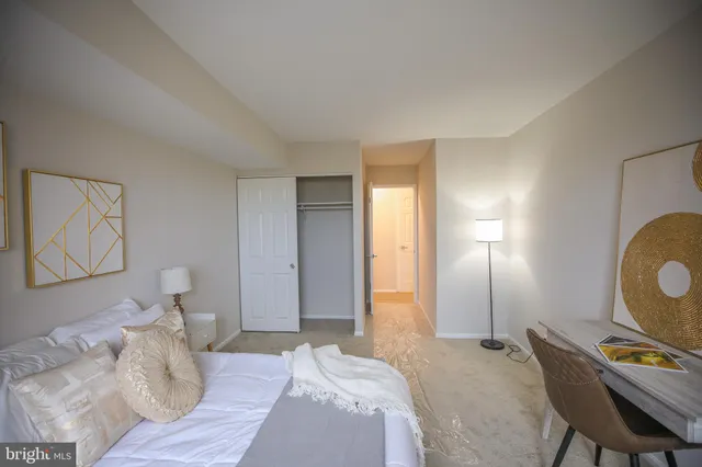 a bedroom with a bed and cabinets