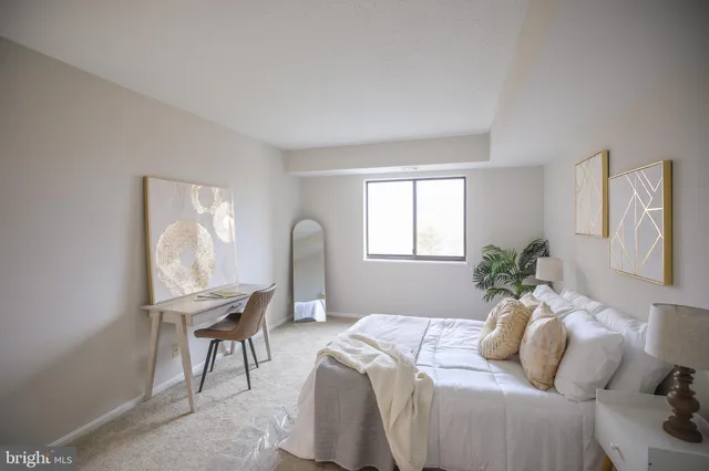 a bedroom with a bed and a chair