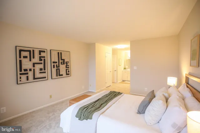 a bedroom with a bed and a painting on the wall