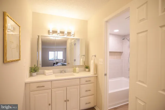 a bathroom with a double vanity sink and a mirror