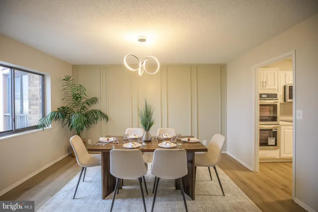 a view of a dining room with furniture and wooden floor