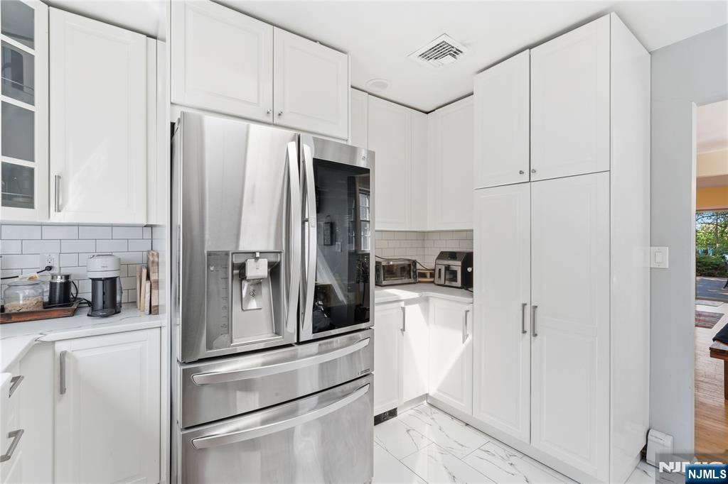 1675 Broad Street Bloomfield, NJ 07003 - Photo 8 of 35 a kitchen with stainless steel appliances a refrigerator and cabinets