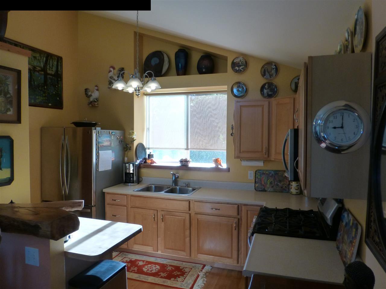 1333 Haiku Road Haiku, HI 96708 - Photo 3 of 30 a kitchen with a refrigerator and a stove