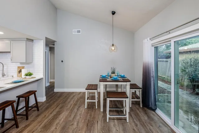 a view of a workspace with furniture window and wooden floor