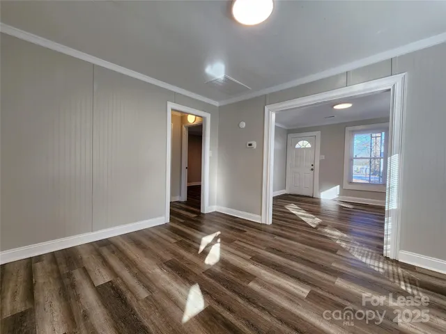 a view of wooden floor and windows in a room