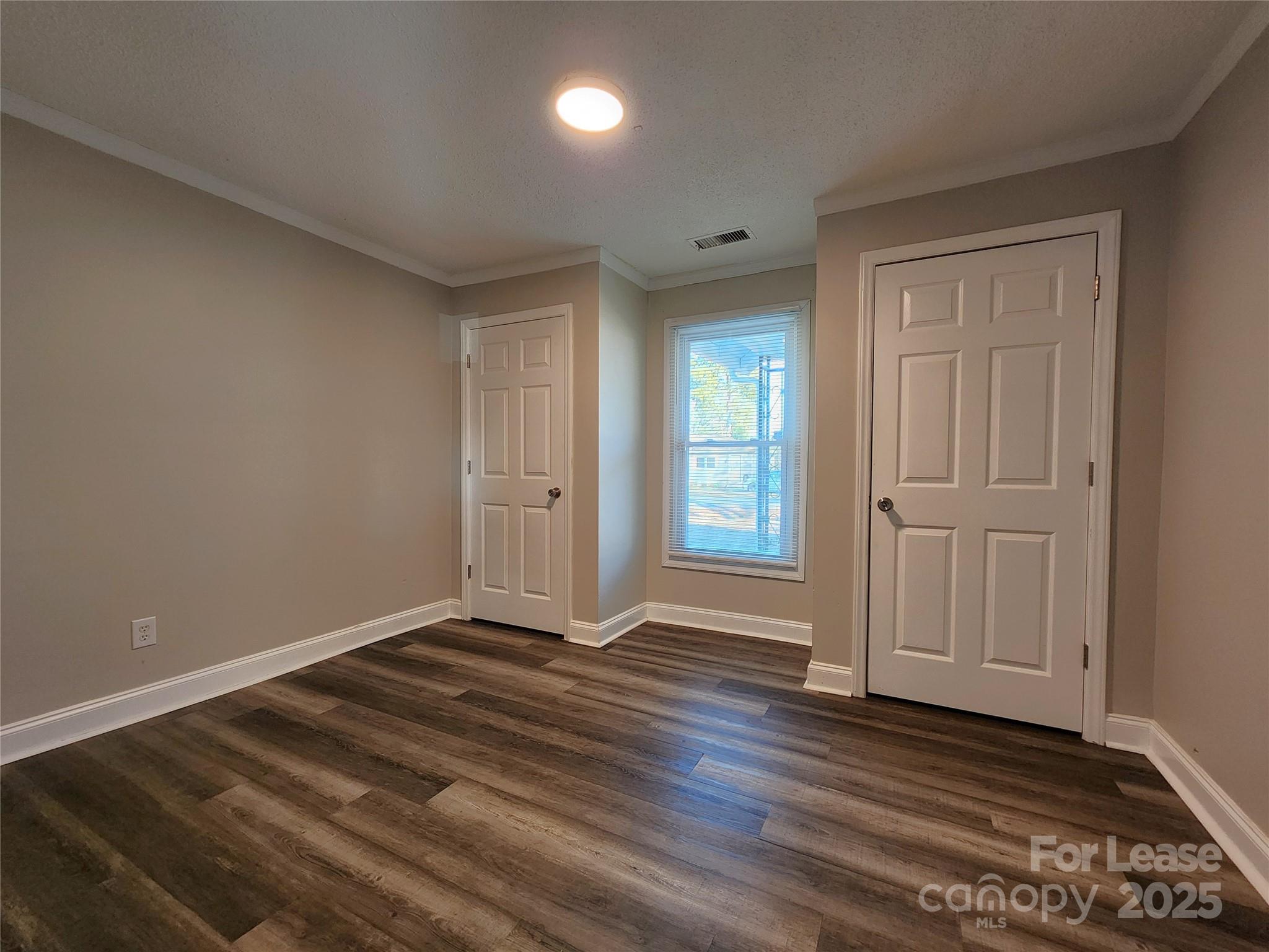 2802 Maryland Avenue Kannapolis, NC 28083 - Photo 8 of 19 a view of an empty room with wooden floor and closet