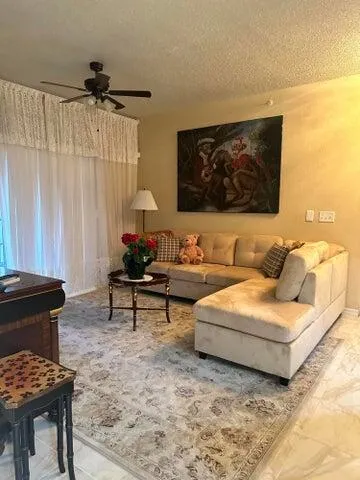 a living room with furniture and a piano
