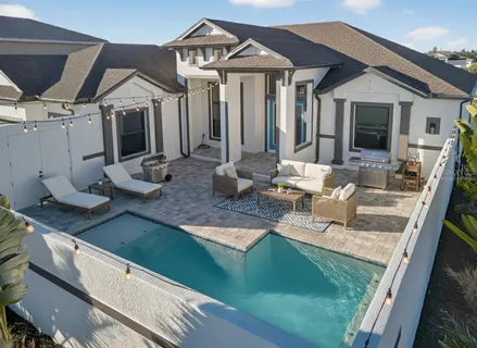 a view of a house with backyard and porch