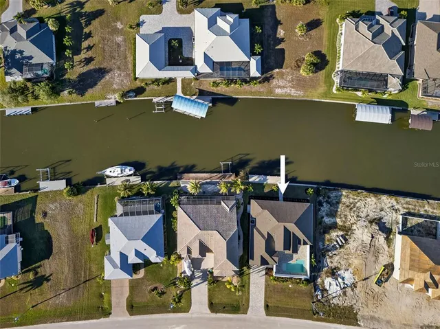 an aerial view of a house with a yard