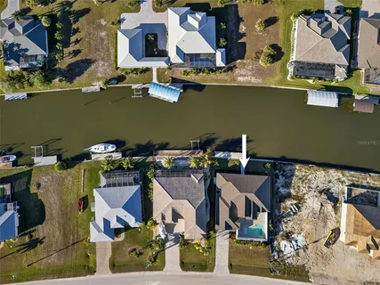 an aerial view of a house with a yard