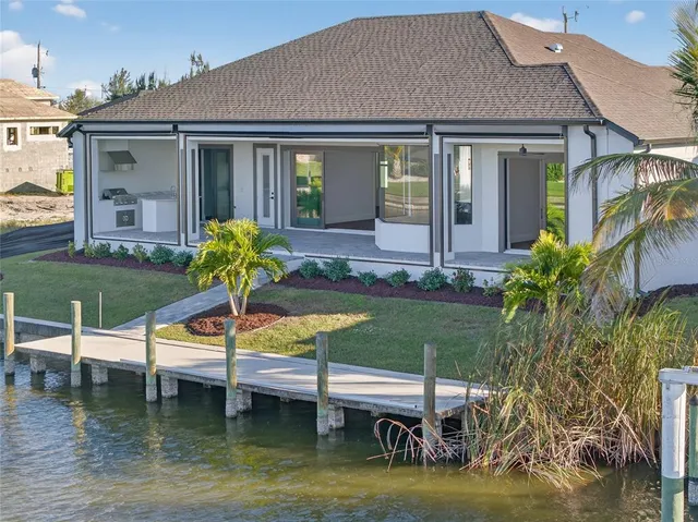 a view of a house with backyard and porch