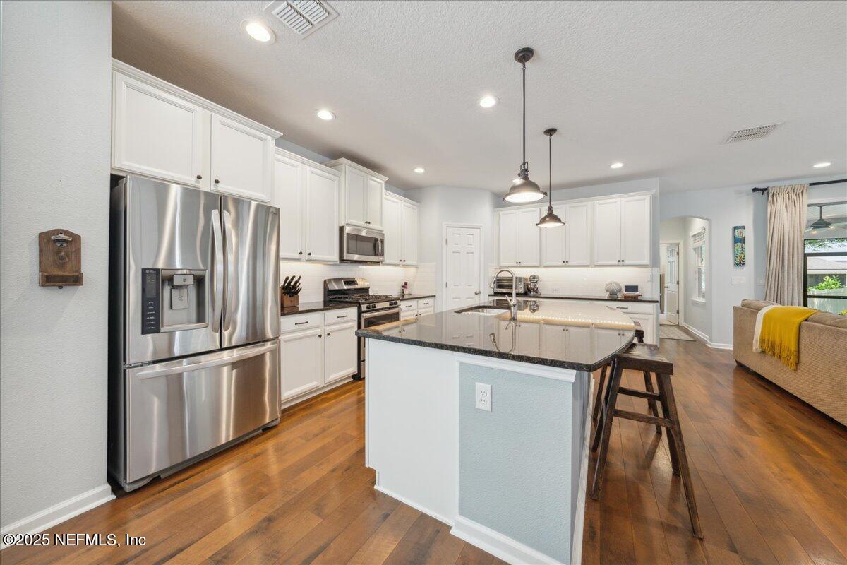 31 Skylar Lane Ponte Vedra, FL 32081 - Photo 8 of 32 a kitchen with counter top space a sink appliances and cabinets