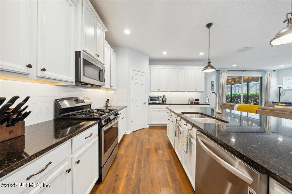 31 Skylar Lane Ponte Vedra, FL 32081 - Photo 9 of 32 a kitchen with stainless steel appliances a stove sink microwave and cabinets