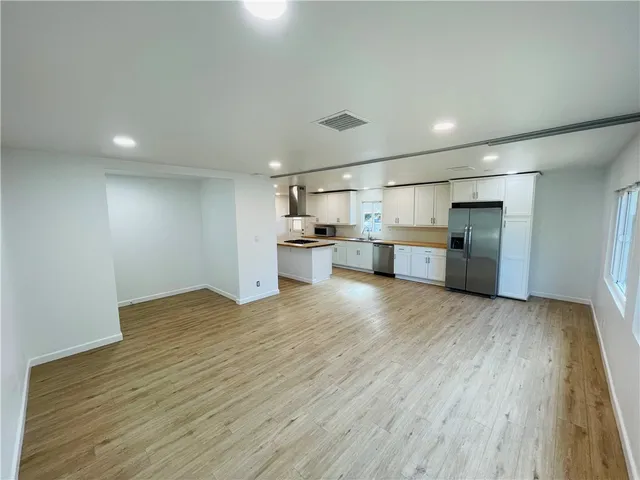 a view of a kitchen with a sink and a refrigerator