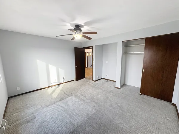 a view of an empty room with a ceiling fan